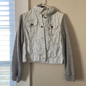 White jean jacket with sweater sleeves